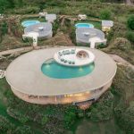 onion expands nature-inspired resort with pool villas atop thai mountains