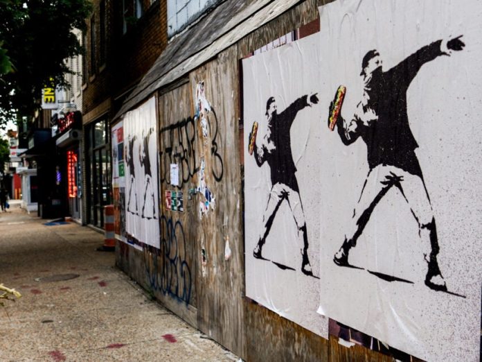 The man who threw a sandwich at a federal agent says it was a protest. Prosecutors say it’s a crime.